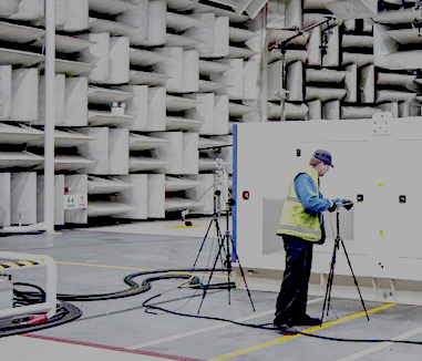 Technician in power generator noise reduction chamber